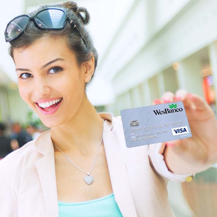 Smiling woman with WesBanco Personal Credit Card in Mall