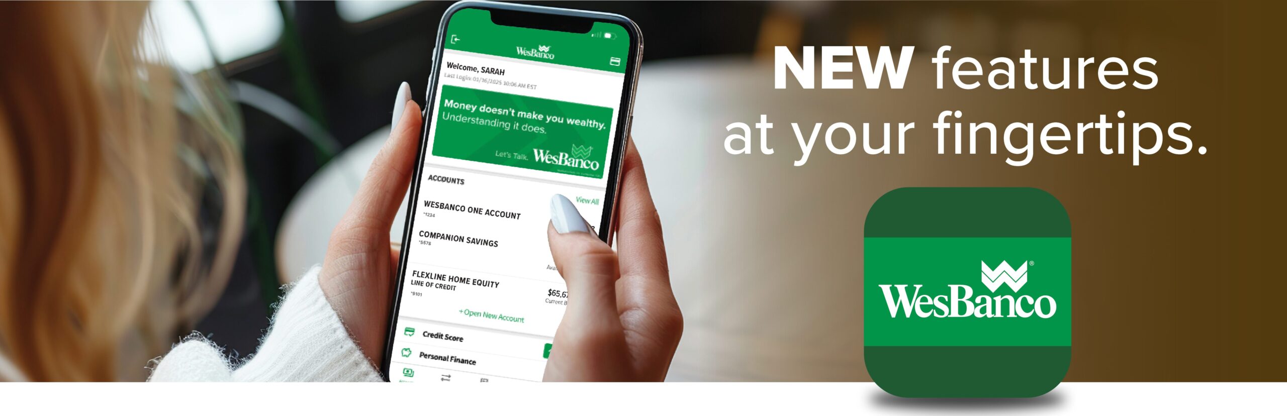 New Features at Your Fingertips. woman's hand holding an iphone with WesBanco mobile app showing